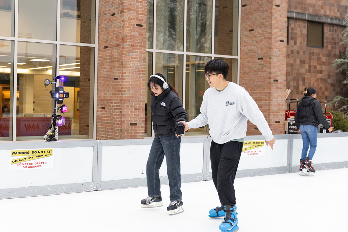 Students ice skate together
