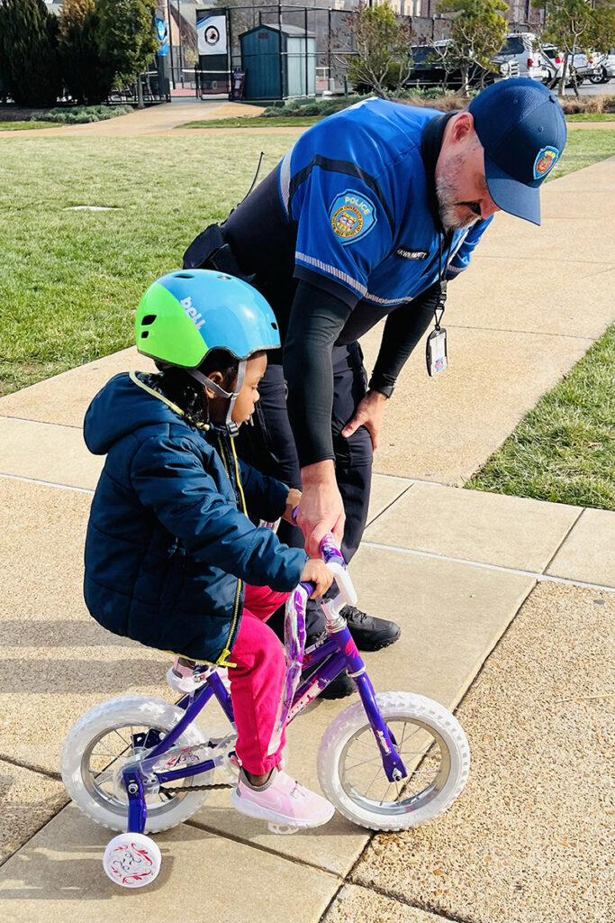 WUPD officer helps child with bike