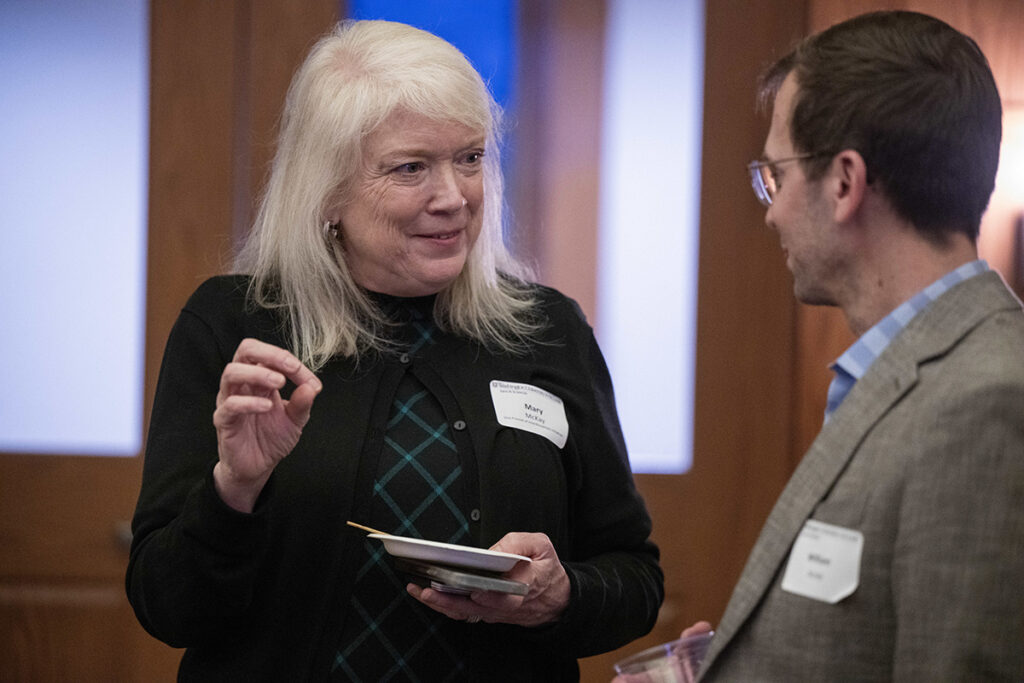 Mary McKay speaks with another attendee