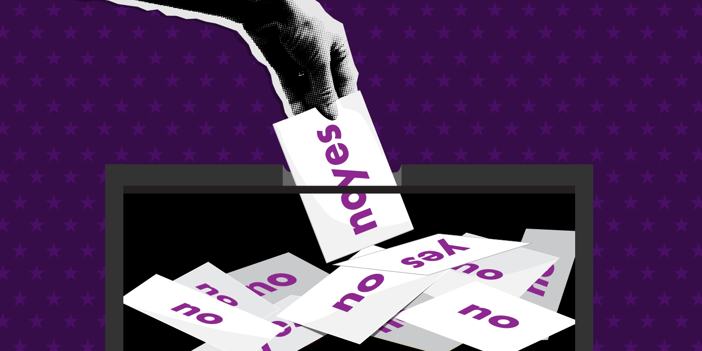 hand with paper votes of yes and no