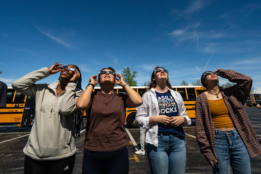 A group looks up at the sky during the solar eclipse