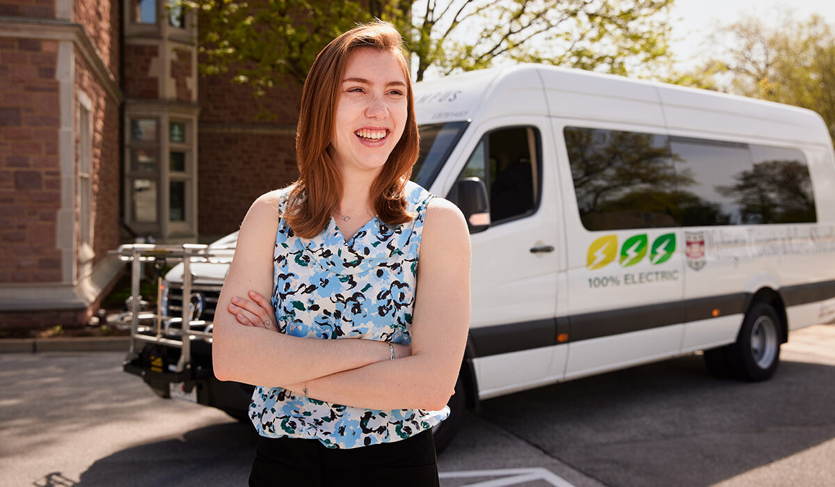 Lauren Bruhl in front of an electric shuttle