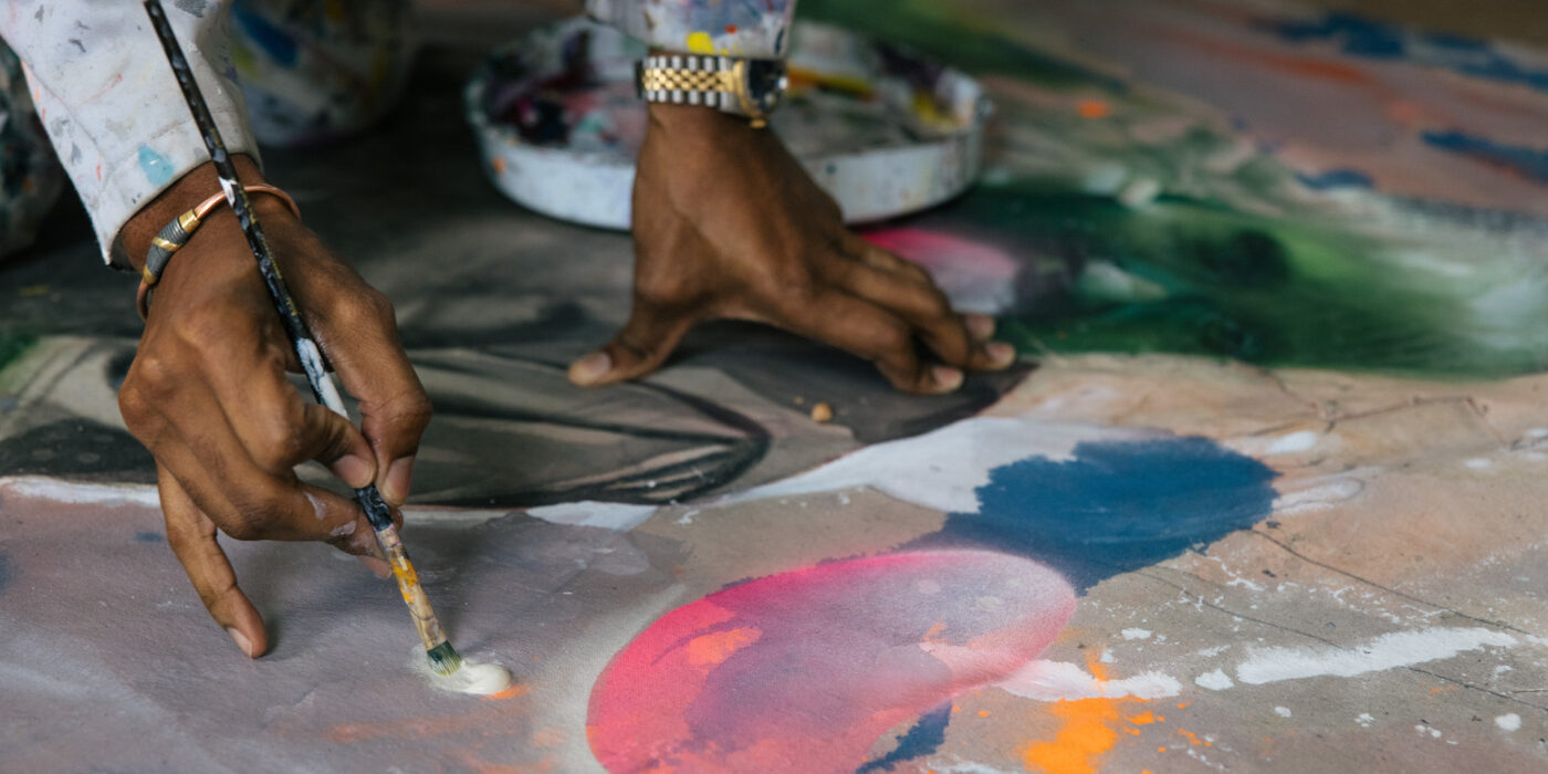 Lavar Munroe paints in his Baltimore studio. (Photo: Alyssa Schukar)