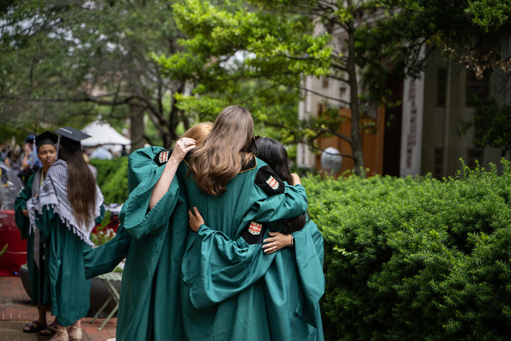 Graduates hug one another